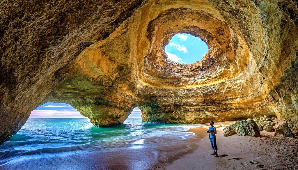Seaside cliff view with turquoise ocean and sunset sky