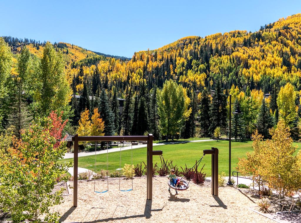 Children climbing on a wooden playground in the forest