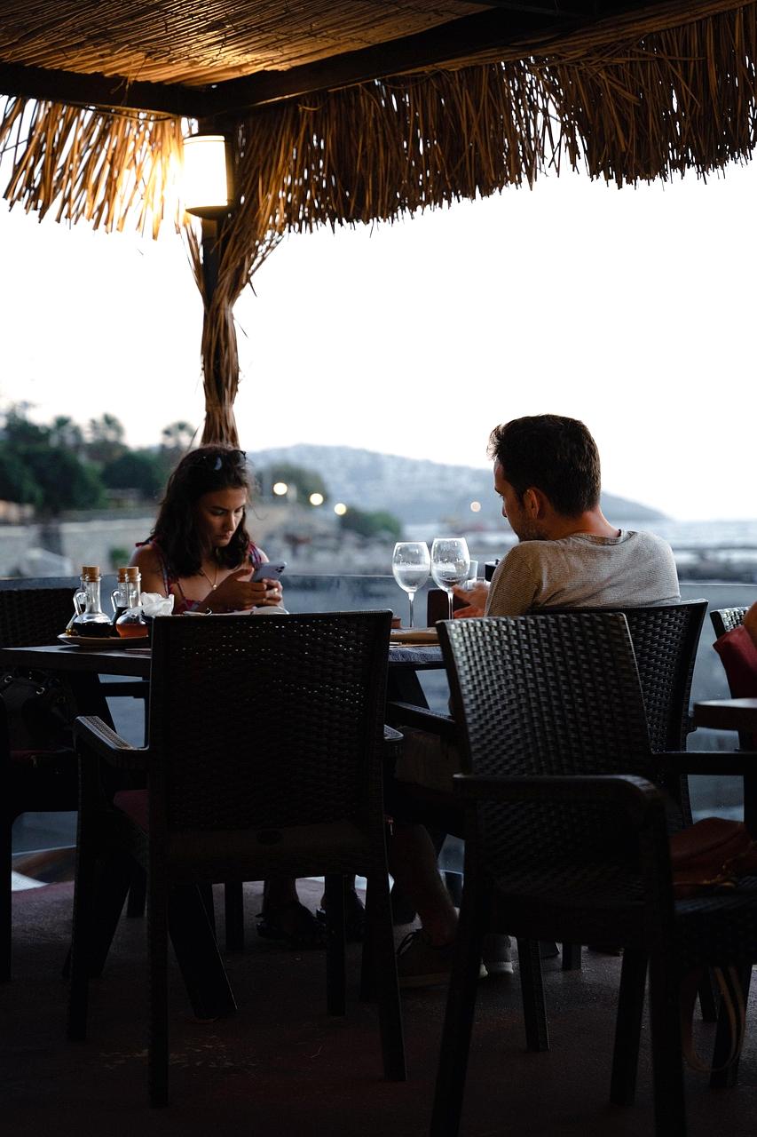 Couple enjoying candlelight dinner on a private terrace overlooking ocean